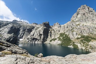Mountain lake Lac de Melo surrounded by cliffs