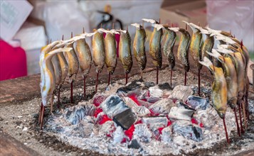 Grilled fish over fire at a food stall