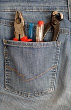 Pliers and screwdrivers in a back pocket