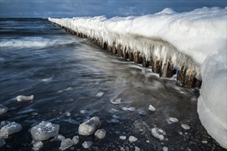 Groynes covered with snow and icicles