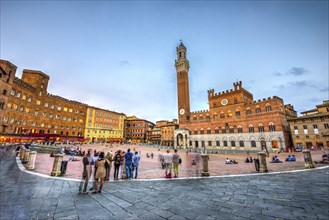 Tourists at the Palazzo Pubblico with Mangia Tower and Chapel