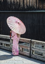 Japanese woman with pink kimono and Japanese parasol