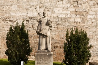 Statue of the preacher Thomas Muntzer in front of the city walls of Muhlhausen