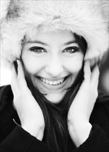 Smiling young woman wearing a fur hat