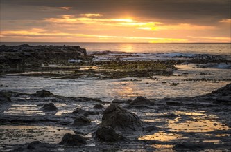 Landscape with sunset on the rocky coast