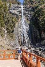 Tourist looks at Nachi Waterfall at Seigantoji Temple
