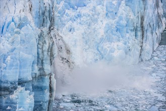 Ice breaking off the glacier wall