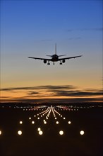 Aircraft landing at sunset