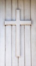 Wooden cross on the front door of a chapel