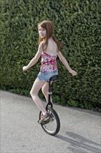 Girl riding the unicycle