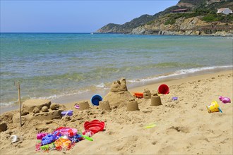 Sand castle and beach toys on the beach