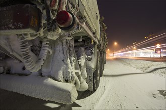 Snow-covered vehicle in winter
