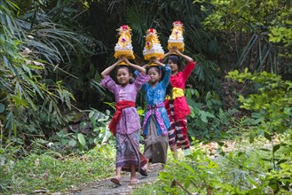 Three girls walking to the temple