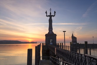 Statue of Imperia at the entrance of the harbour of Konstanz at sunrise