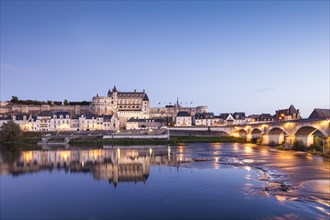 The walled town and Chateau of Amboise reflected in the River Loire in the evening