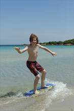 Boy surfing with his boogie board