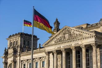 German flag flying next to the Reichstag building
