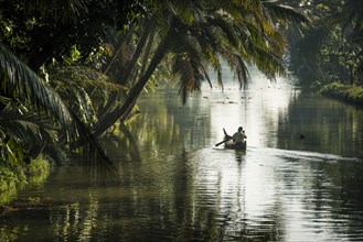Man in a small wooden boat