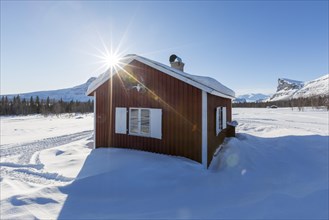 Wooden huts STF Aktse Fjallstuga in winter