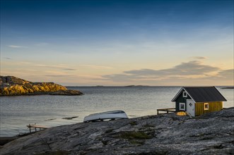 Fisherman's cottage by the sea at sunset