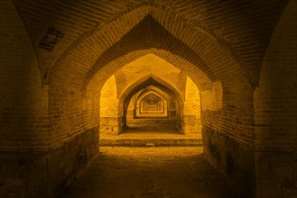 Arches under the illuminated Si-o-se Pol Bridge or Allah-Verdi Khan Bridge