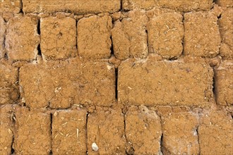 Clay brick wall with straw