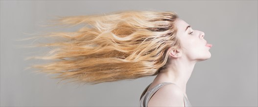 Woman with flying long blond hair