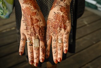 Henna-painting on hands at a wedding ceremony