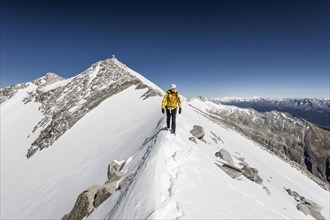 Mountaineer on the summit ridge descending from the Hoher Weisszint