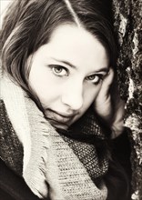 Thoughtful young woman wearing a scarf