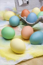 An assortment of colorful Easter eggs drying on paper towels