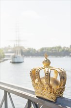 Golden crown on bridge in central Stockholm