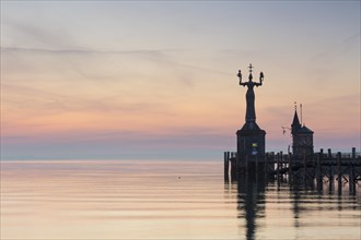 Statue of Imperia at the entrance of the harbour of Konstanz at dawn