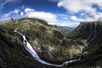 Waterfall with the Trollstigen serpentine mountain road