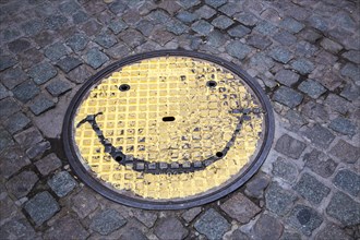 Manhole cover with smiley face