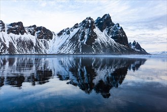 Mountain Vestrahorn with water reflection in the bay of Hornsvik