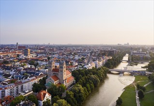 City view with Maximilianskirche and Reichenbach bridge over Isar at sunrise