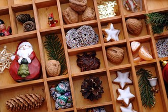 Christmas decorations and sweets in a type case or letter case