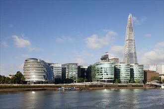Promenade on the River Thames with City Hall and Shard skyscraper