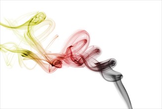 Colourful smoke from an incense stick or joss stick