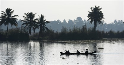Woman taking children to school in a small boat