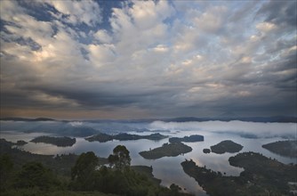 Dramatic clouds and fog at sunrise above the islands of Bunyonyi Lake