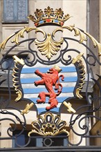 Coat of arms with lion figure on railing