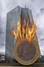 Euro coin going up in flames in front of the European Central Bank building