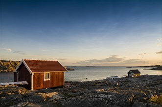 Fisherman's cottage by the sea at sunset