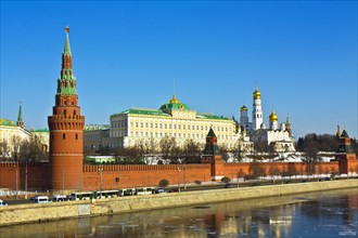 Moscow Kremlin with palace and cathedrals on bank of Moskva River with reflections