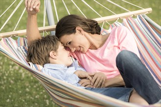 Mother and son lying in hammock
