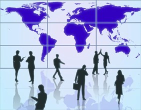 Business people in front of a world map
