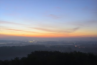 View from the Halde Norddeutschland spoil tip onto the Lower Rhine and the western Ruhr district at dawn