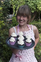 Girl presenting her homemade Oreo brownie cupcakes